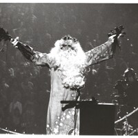 Bill Graham, as Father Time, on a model of the Golden Gate Bridge